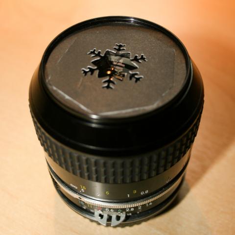 custom snowflake-shaped aperture on a nikkor f1.4 lens