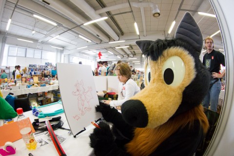 Baseball, sitting at our table and drawing on a giant sketchpad.