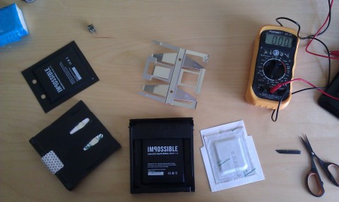 Parts of the Spectra filmpack, the white battery is the original Polaroid battery.